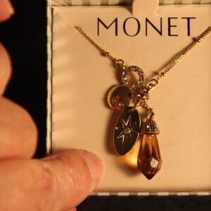 Charm gold tone necklace. Monet brand. New in box.